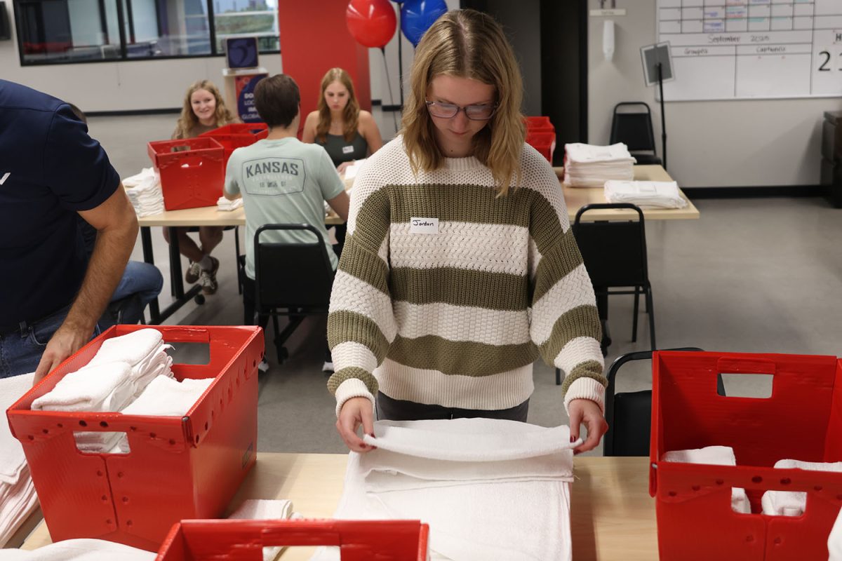 Finishing up folding the last couple of towel, senior Jordan Powell helps contribute to Heart to Heart, Thursday, Sept. 18.