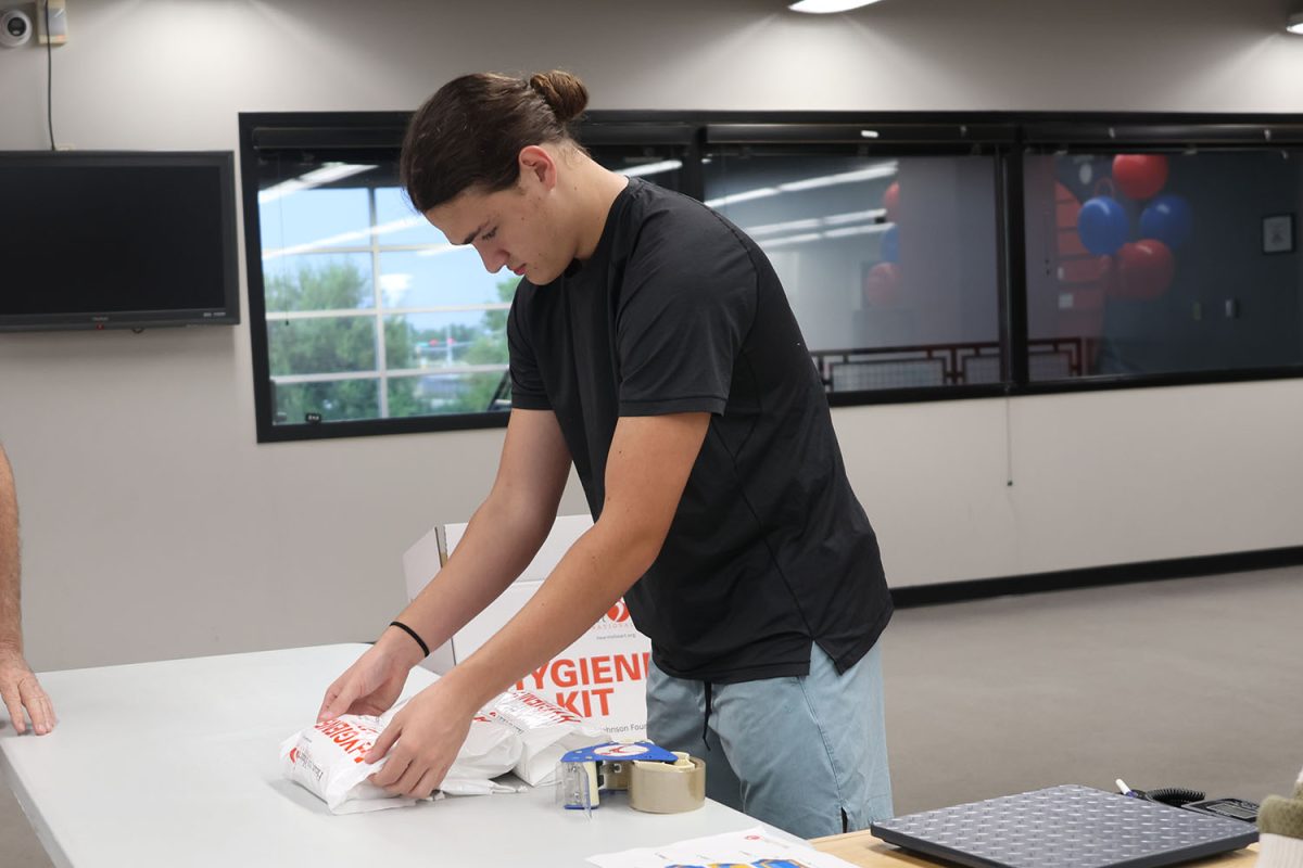 Stocking up the hygiene kits, senior Keegan Wootton counts each kit on his side of the table, Thursday, Sept. 18.