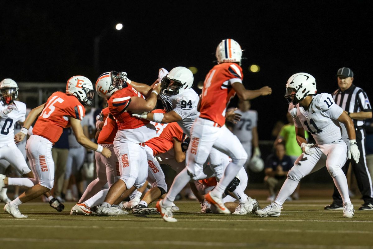 Senior Hayden Heller blocks an Olathe East player from advancing.