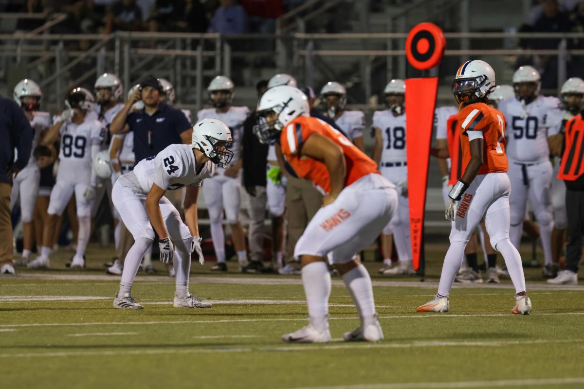 Senior Jenner Scobee prepares to block an Olathe East player