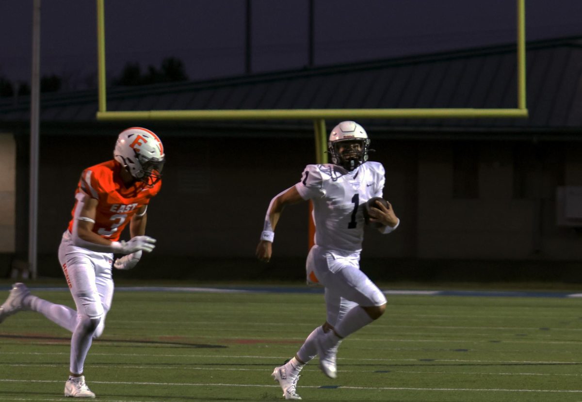 Running from an Olathe East defender, senior Blake Jay runs for a first down. 