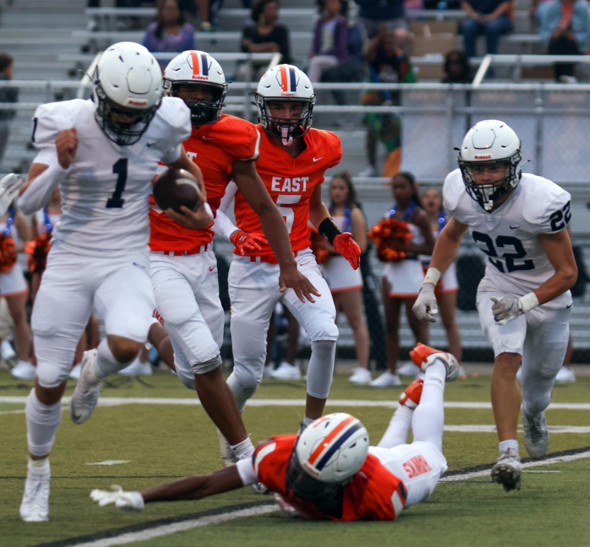 Senior quarterback Blake Jay jumps over an Olathe East defender to make a first down