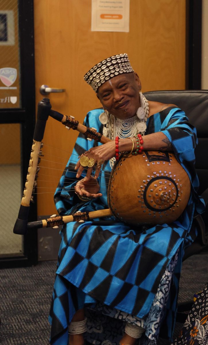 Smiling, speaker Charlotte Hill O'Neal sings one of her original songs.