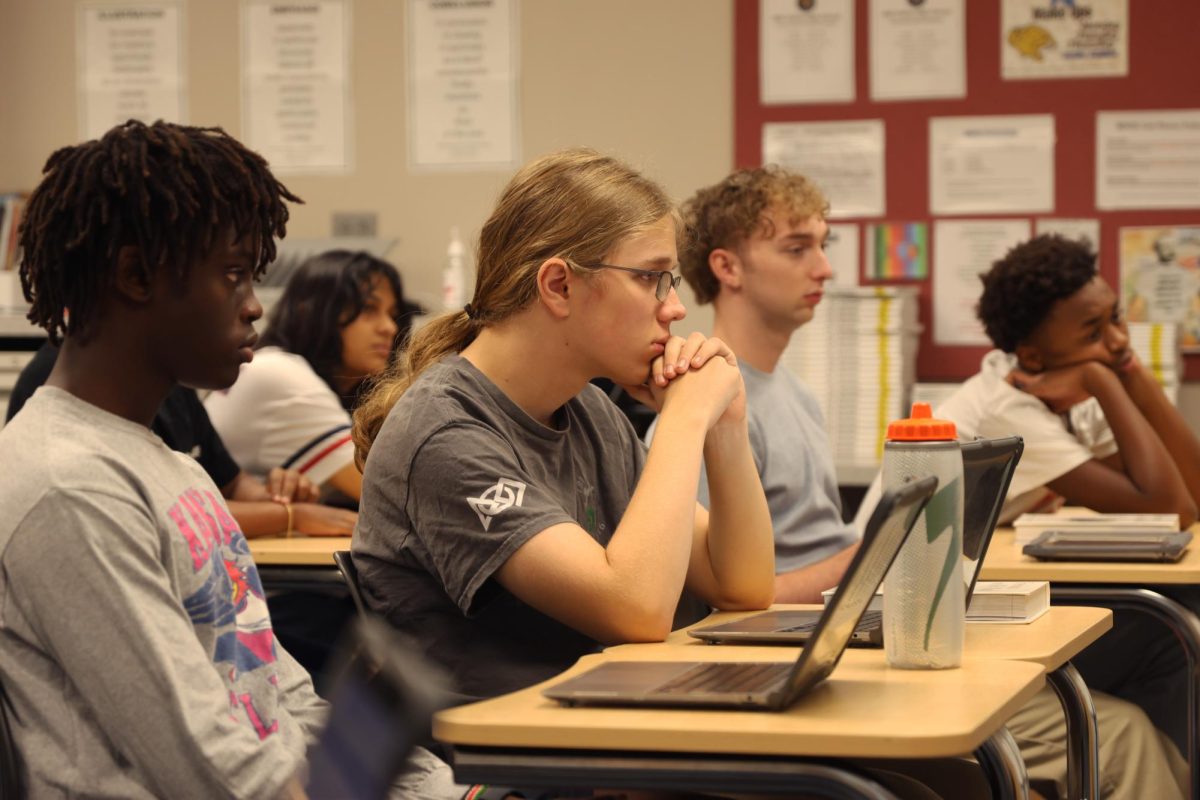 Looking forward, senior Andrew Heideman listens to the speaker's story about Africa.