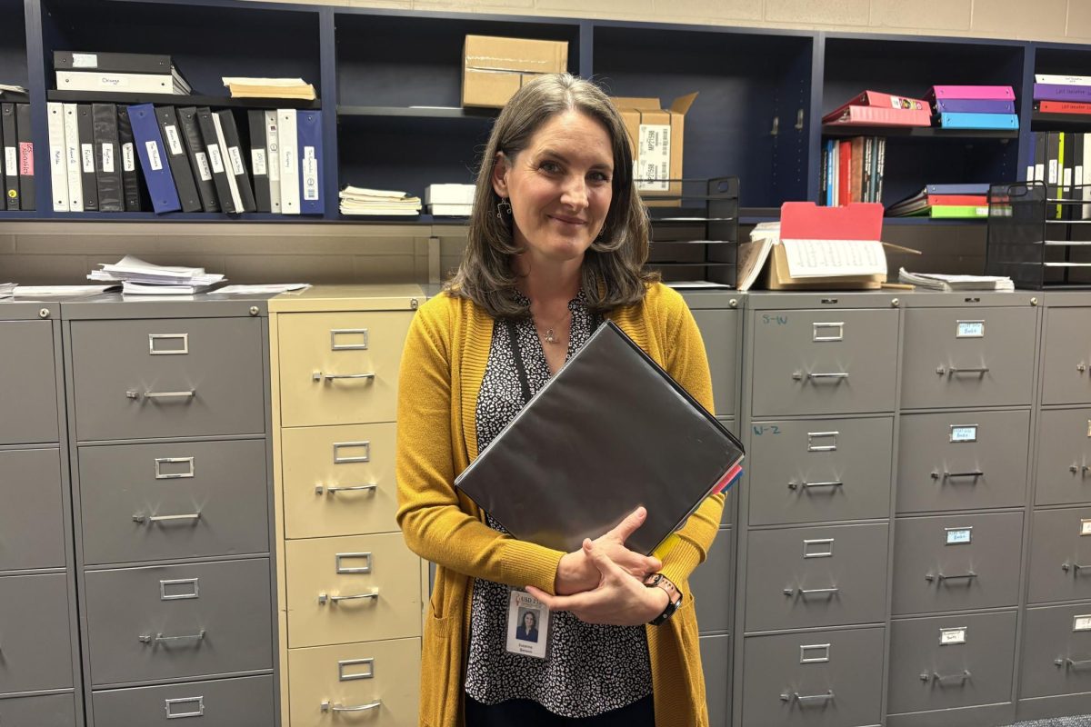 Choir accompanist Suzie Benson holds her binder of music, her binder is important to her because it holds all of her sheet music. 