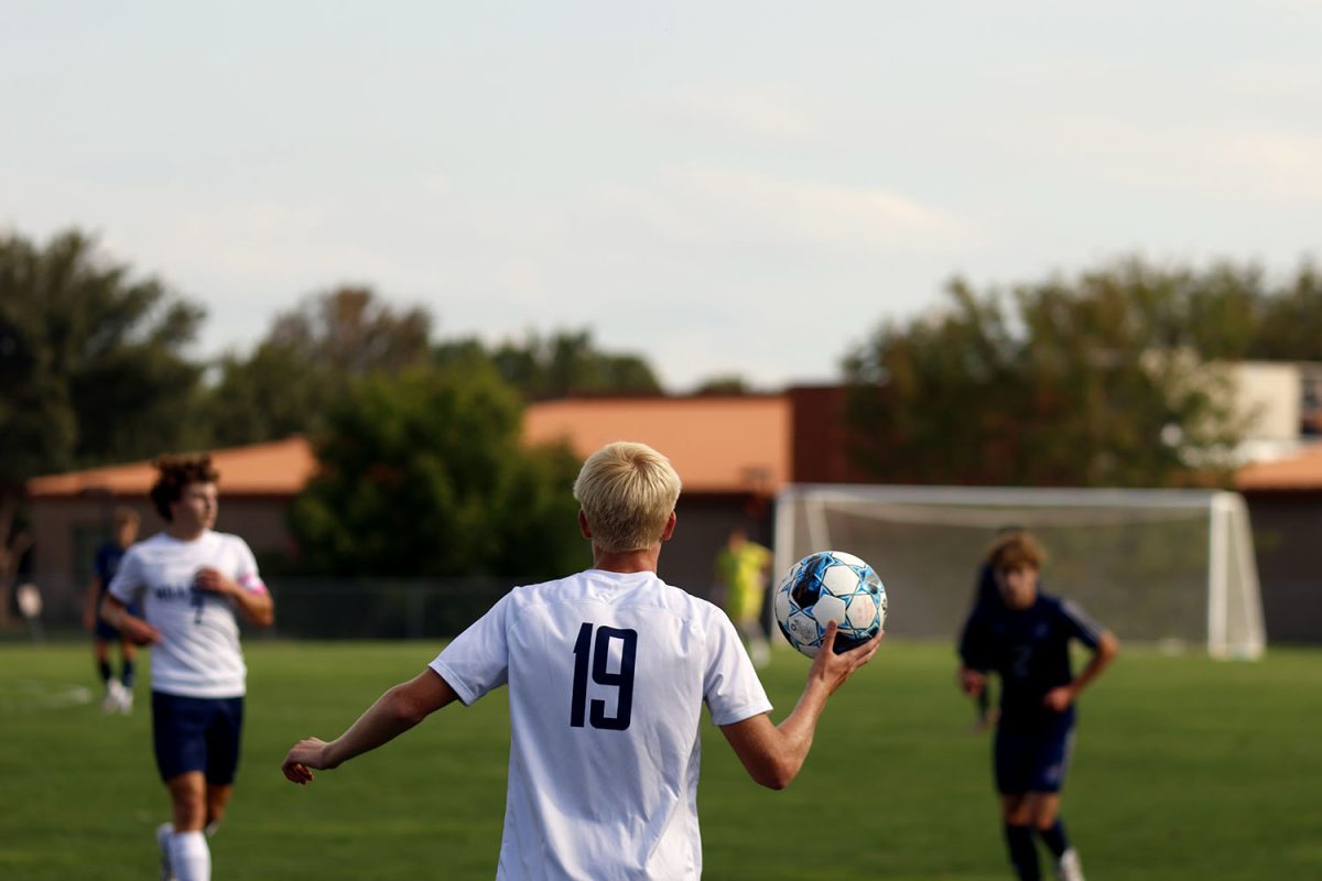 Sophomore Josiah Hayes prepares to throw the ball in after the ball was kicked out by St. James. Tuesday Sept. 2.