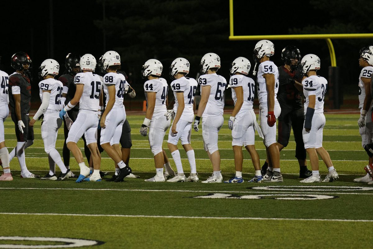 After losing, the football team shakes hands with Lee Summit.

