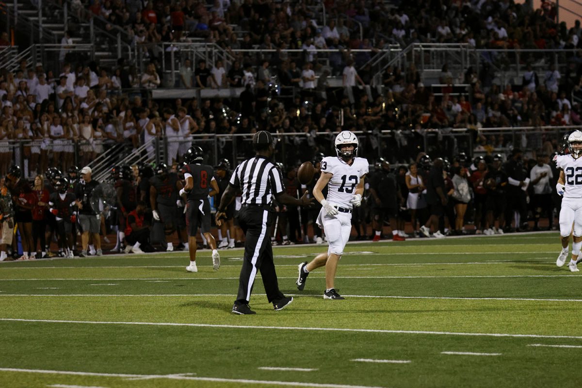 Senior Bryce Shorten throws the ball to a referee after gaining a few yards. 