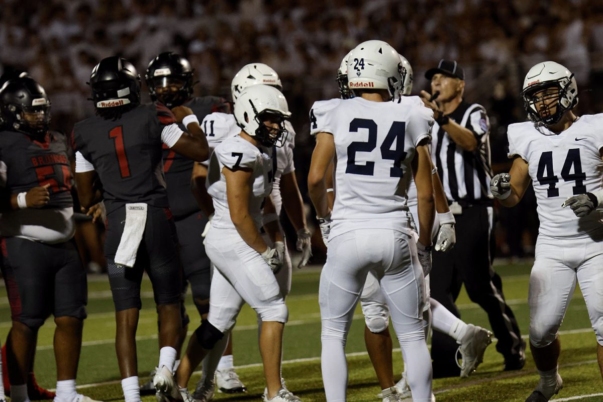 The football team talks over the recent play.