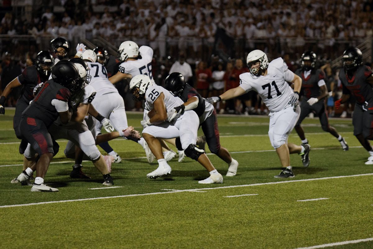 Senior Reggie Reece, supported by his fellow teammate's, pushes through the defense.
