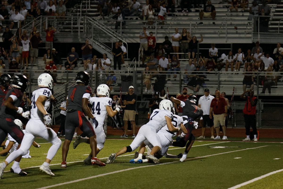 The football team stops Lee Summit, making them lose two yards.
