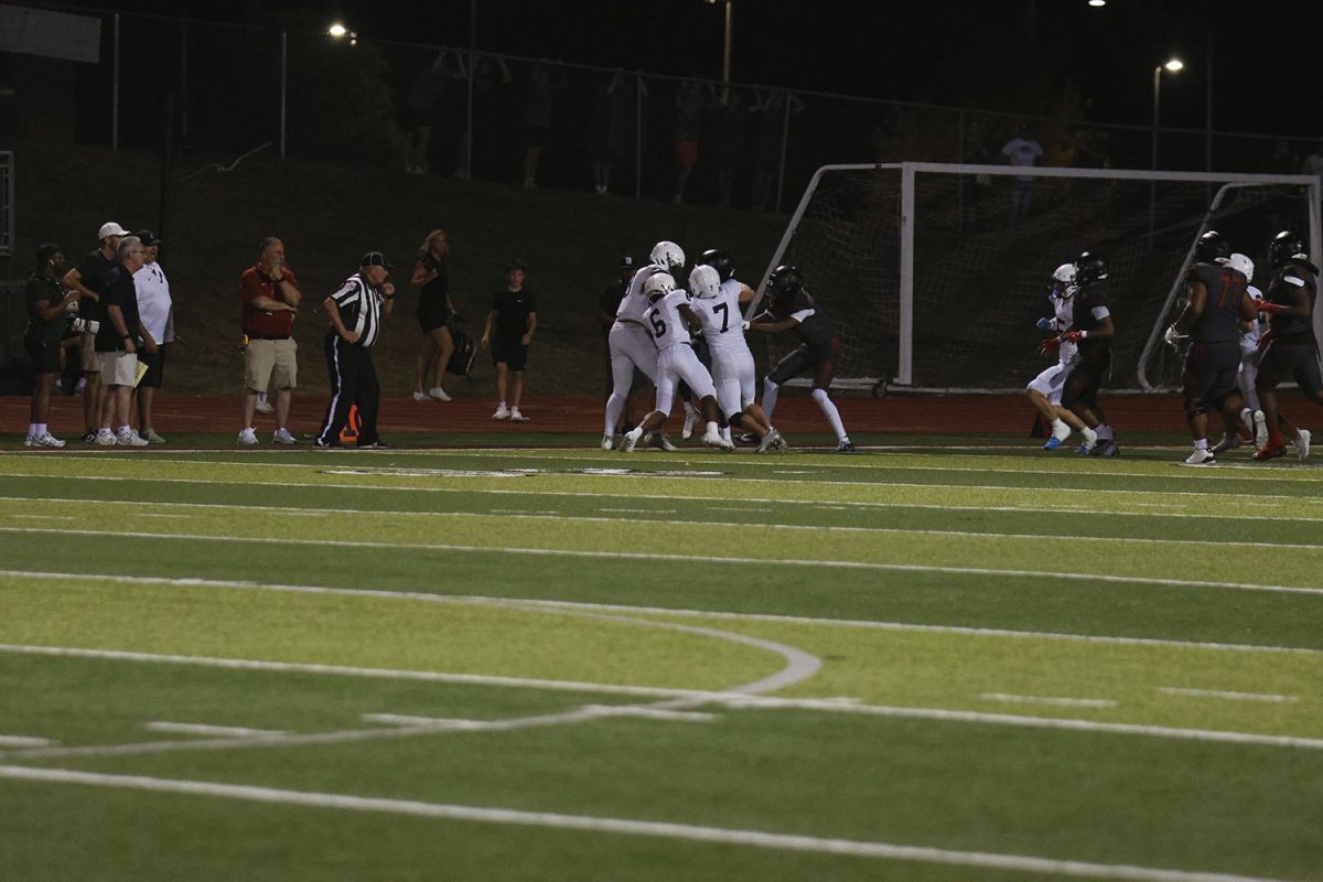 The football team tries to sack Lee Summit.

