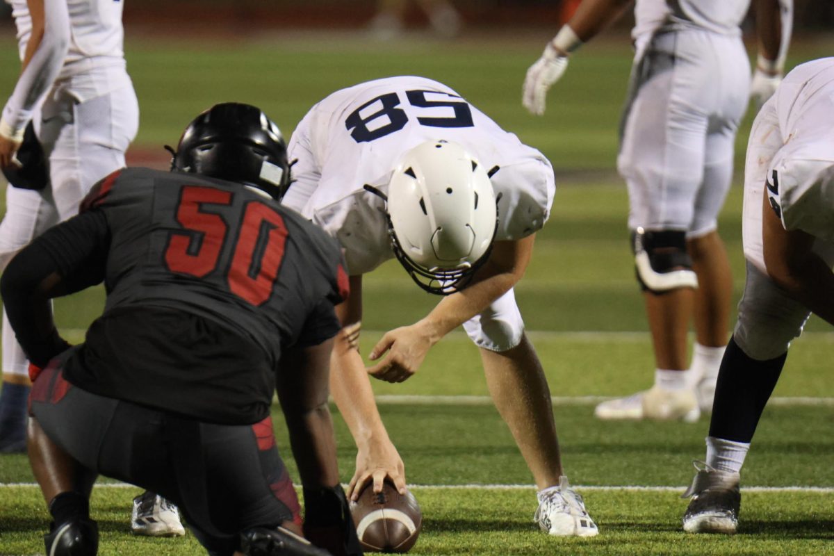 Senior Michael Fitzpatrick prepares to snap the ball against Lee Summit North on sept. 10.