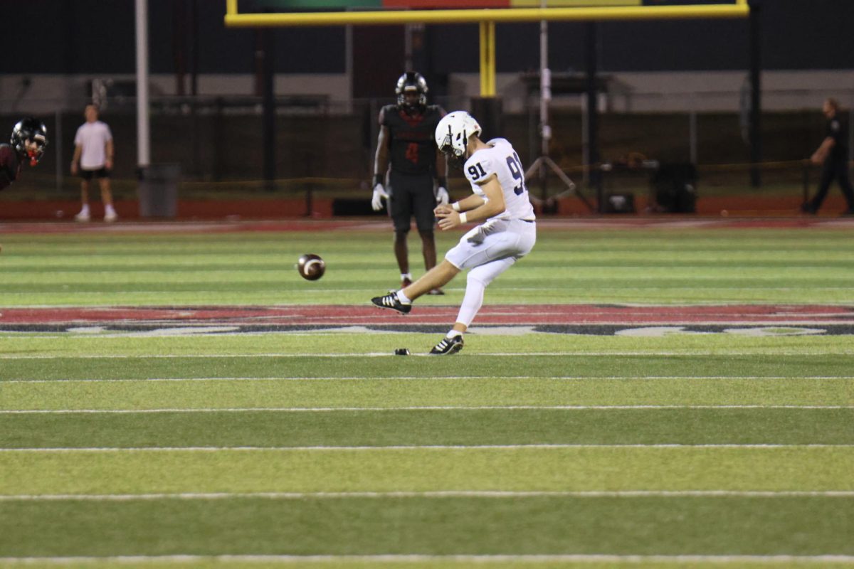 Junior Mason Gallender kicks for a field goal against Lee Summit North on Sept. 4th. 
