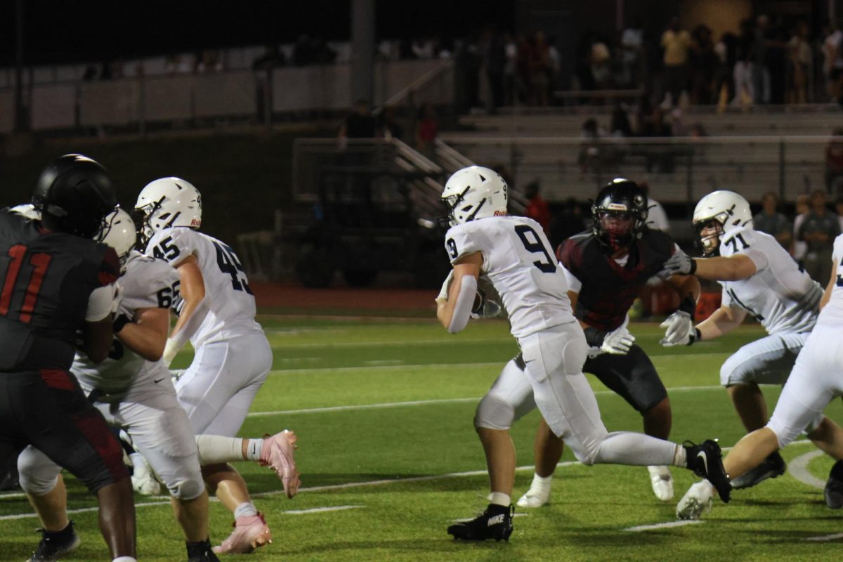 Junior Max Piva runs to get a first down against Lee Summit North on Thursday, Sept. 10 