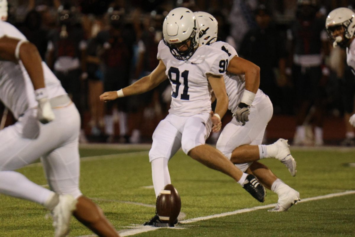 Junior Mason Gallender runs up for a field goal against Lee Summit North on Thursday, Sept. 10.