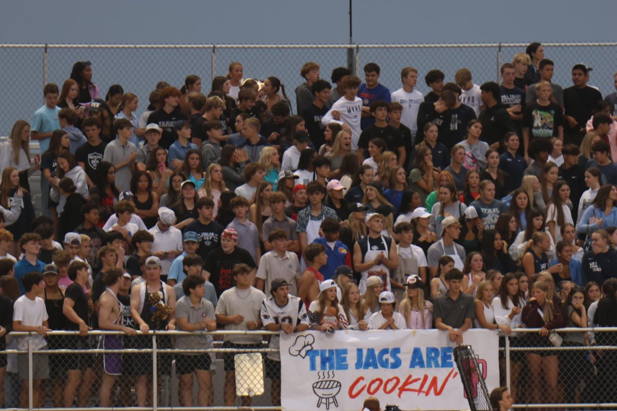 Fans cheering at the Mill Valley vs Olathe East football game to show school spirit on Thursday, Sept. 6.