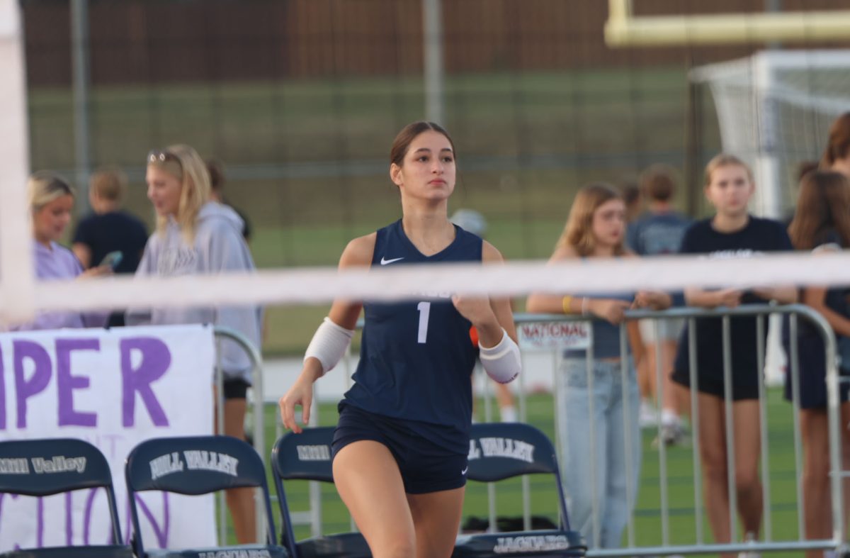sophomore Eylenne Strack runs to join the game after a serve.