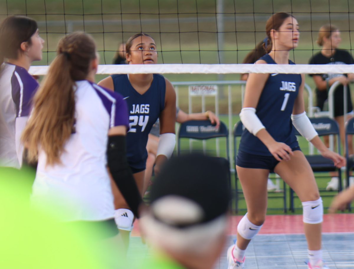 sophomore Julie mills preparing to make a block against the piper pirates on sept. 4th. 