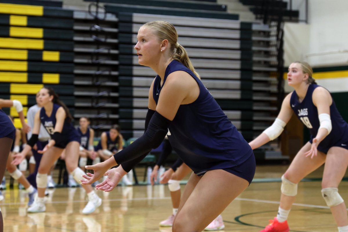 Looking up, junior Josie Danielson prepares for the other team to serve.