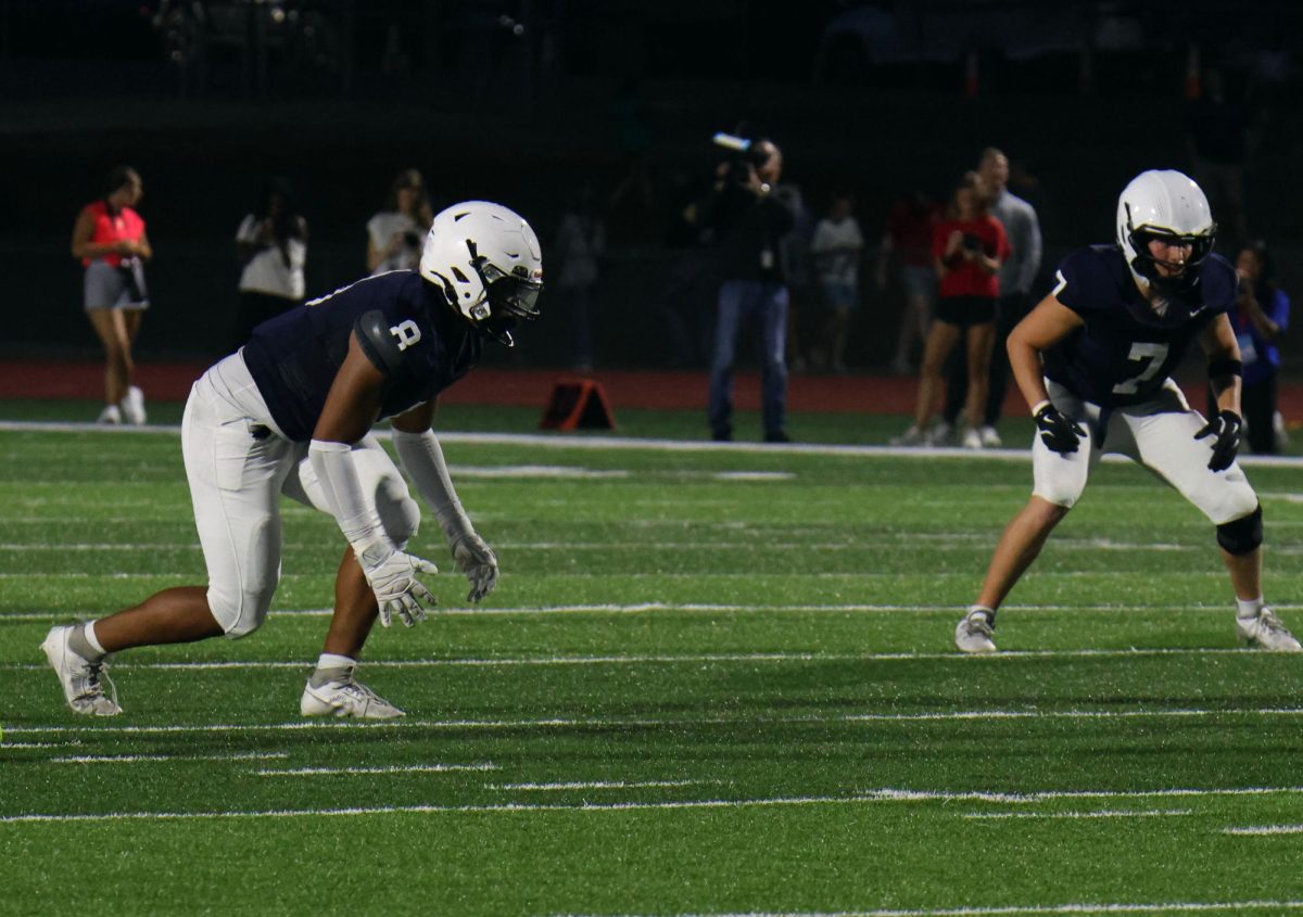 Junior Larry Jones and senior Jaxon Garcia standing in their stance, wait for Shawnee Mission East to start the play.