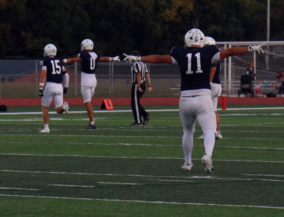 Jaguar defense celebrates after another stop against Shawnee Mission East.
