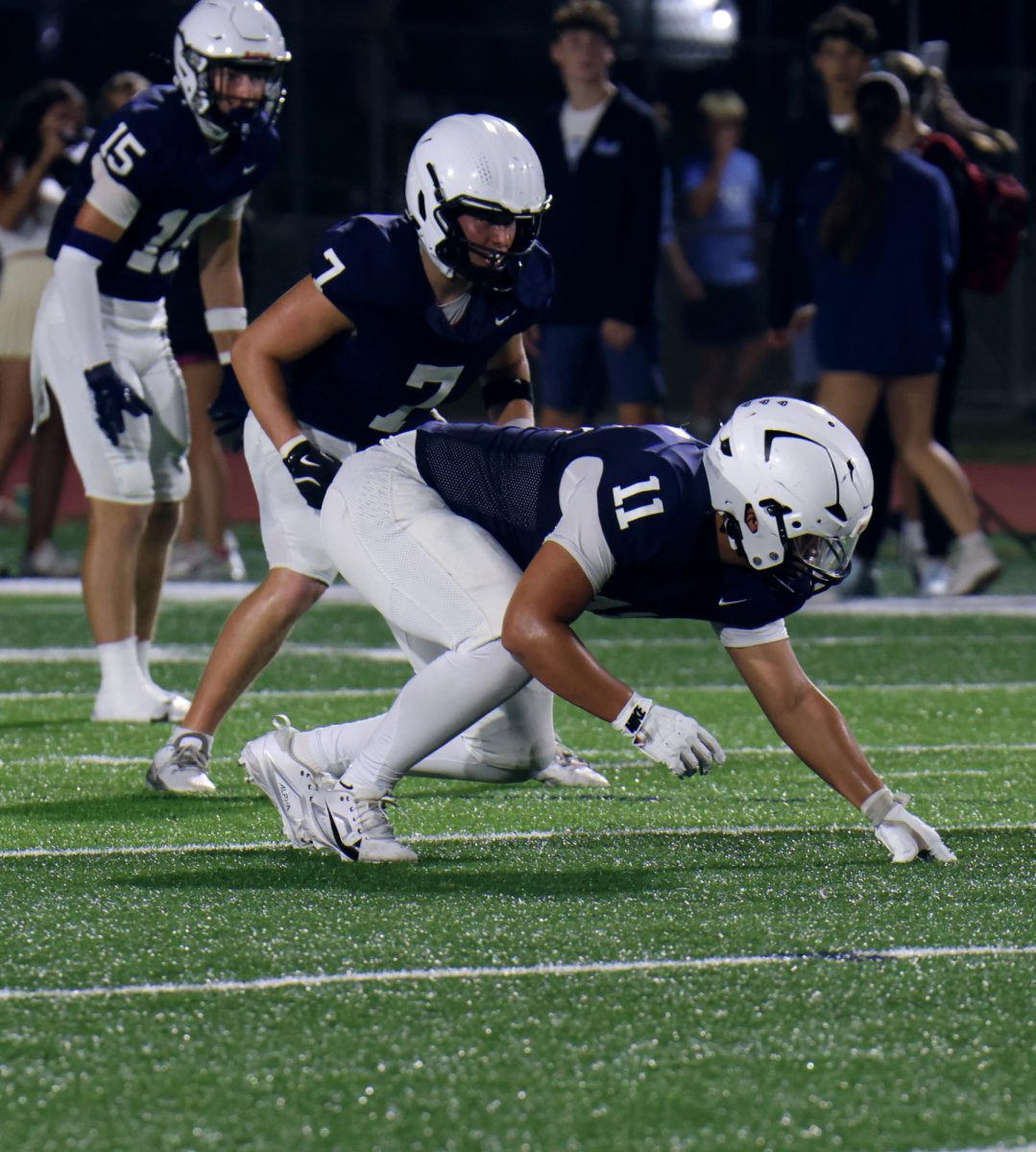 Ready for Shawnee Mission East to snap the ball, junior Josh Garcia gets down in his stance.