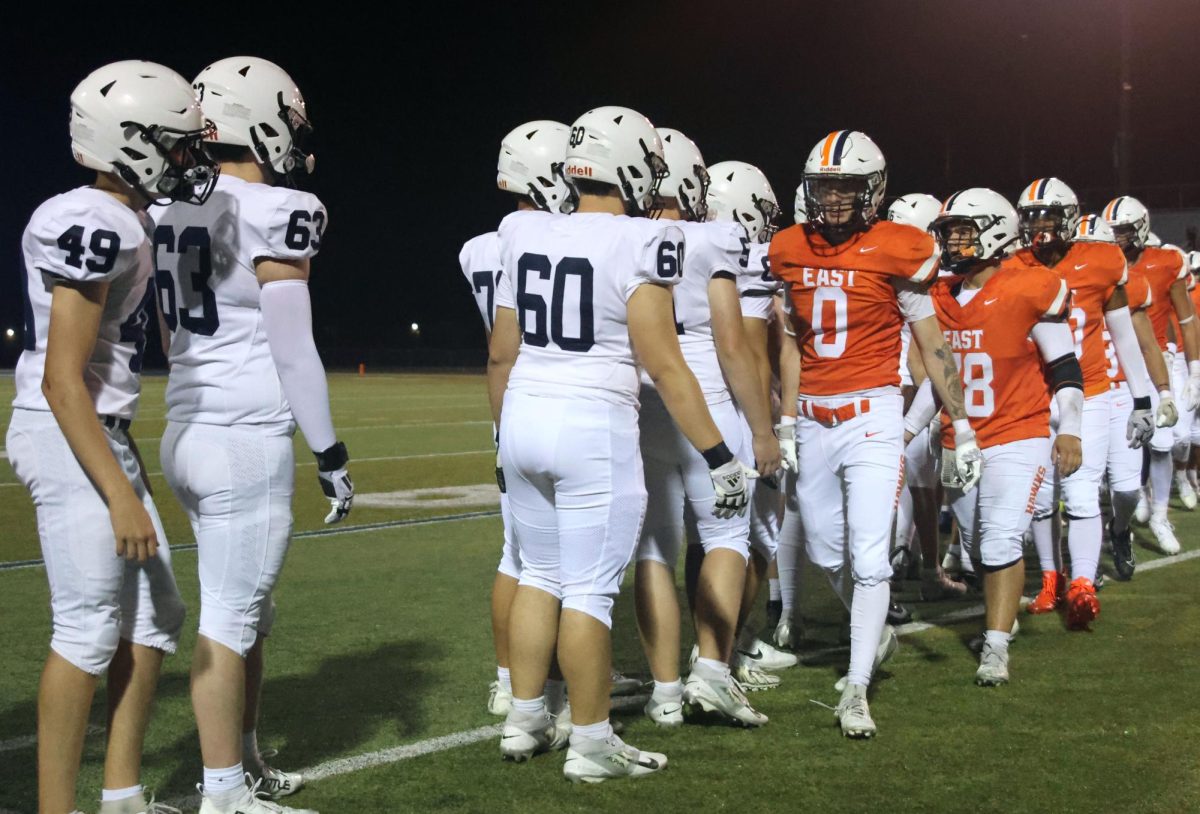 Mill Valley goes through the high five line after the win against Olathe East.