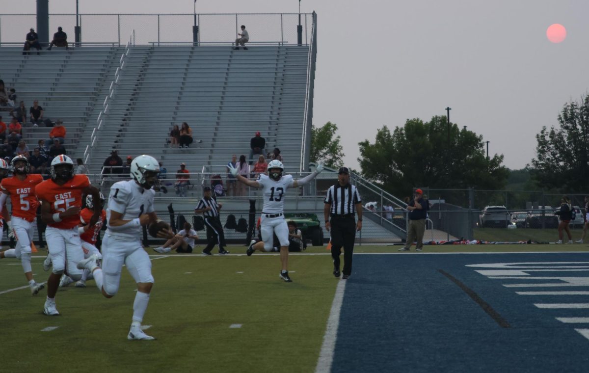 Senior Blake Jay scores the second touchdown of the game, while senior Bryce Shorten cheers him on.