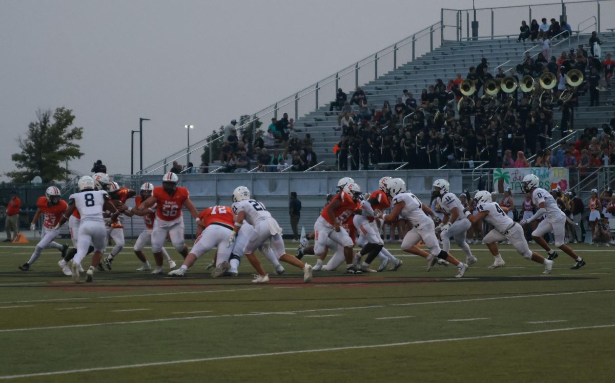 The Jaguar defense lunges towards the offense after Olathe East snaps the ball.