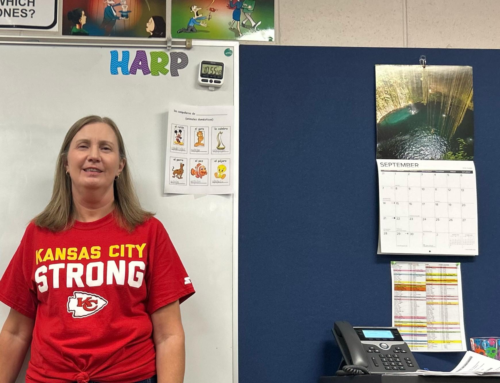 Spanish teacher Jennifer Harp stands next to the board in her room, Harp enjoys having lots of decorations in her classroom. 