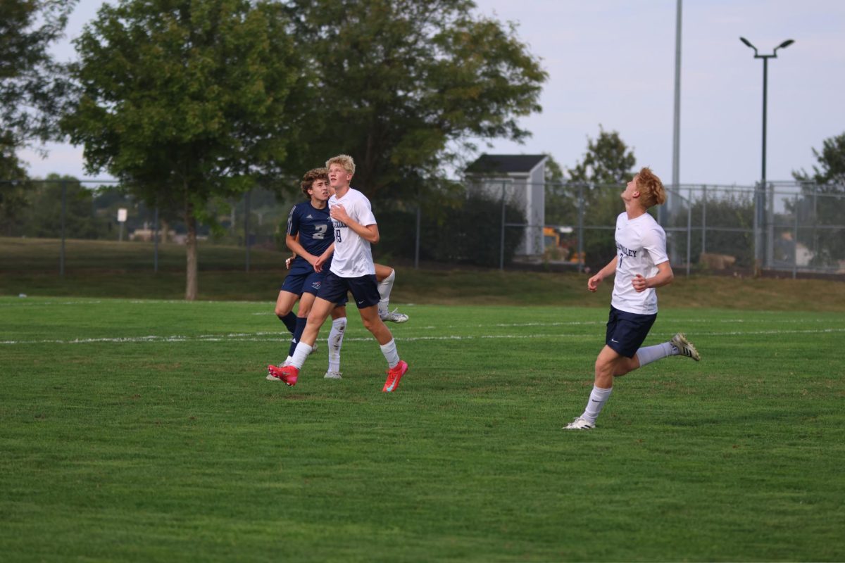 Sophomore Josiah Hayes runs along side senior Caleb Hayes during their game against St. James