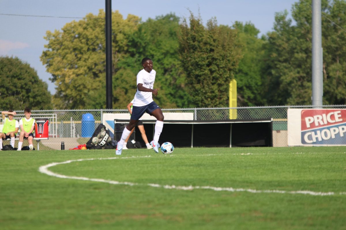 Senior Karington King dribbles the ball to towards the goal. 
