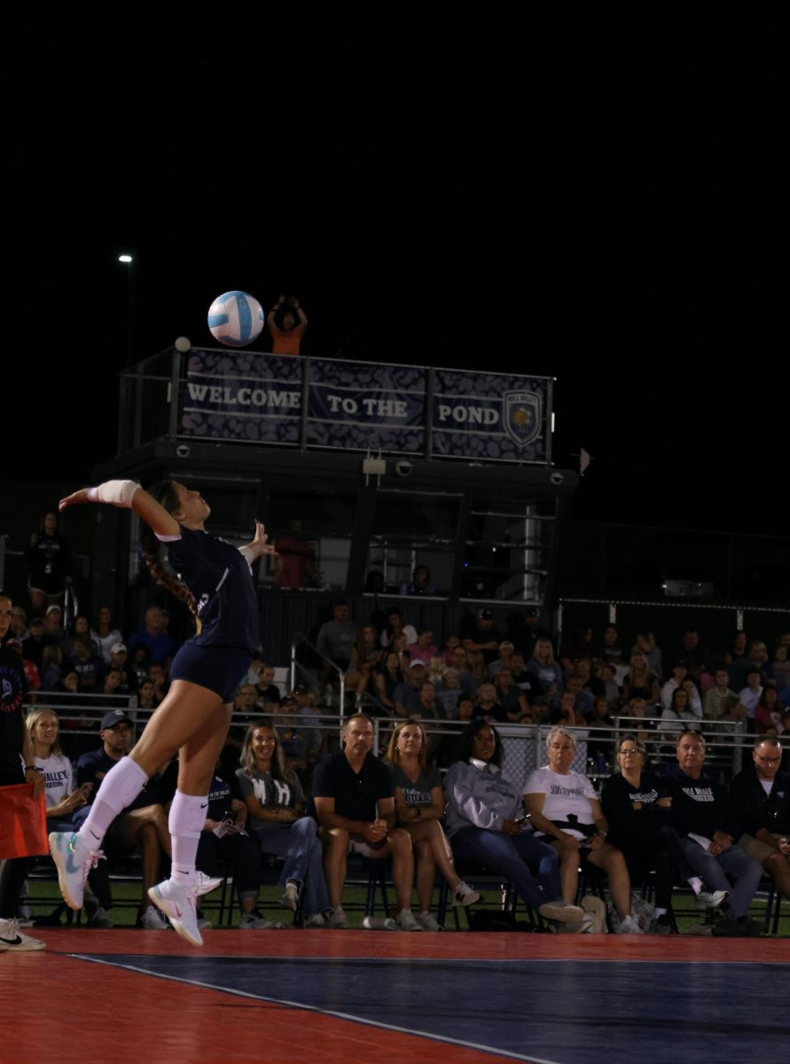 Serving, sophomore Haedyn Lynnes tries to win a point.