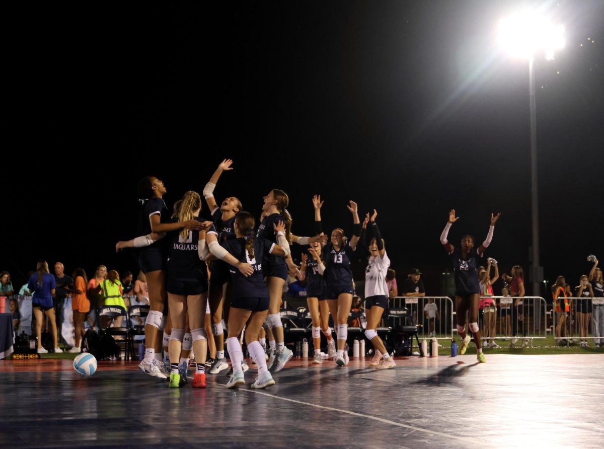 Winning all three sets, the Jags celebrate their historic outdoor volleyball win.
