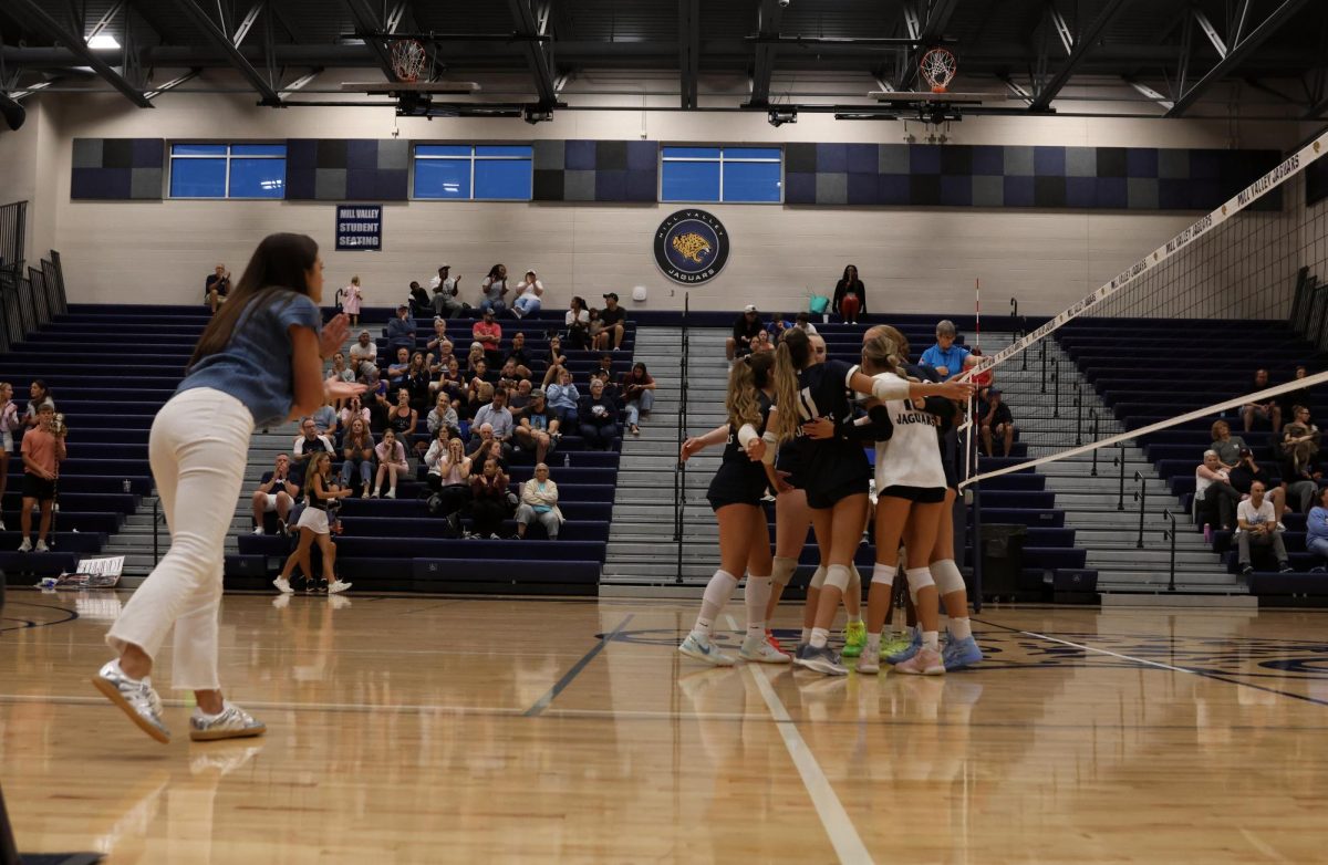 After winning the point, coach Kylie Corneliusen cheers on the Jags.
