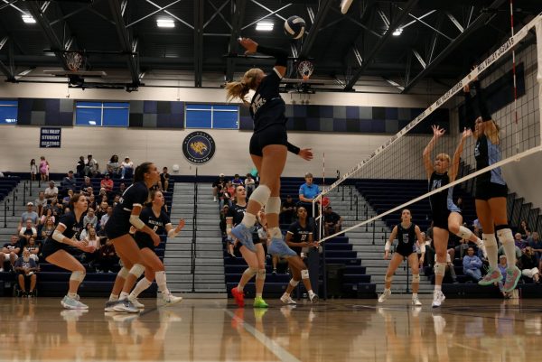 Junior Josie Danielson kills the ball in an attempt to win the point.