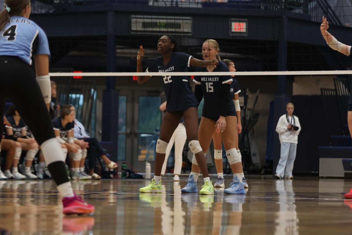 Junior Josie Danielson and senior Olivia Nzioki prepare for the serve.