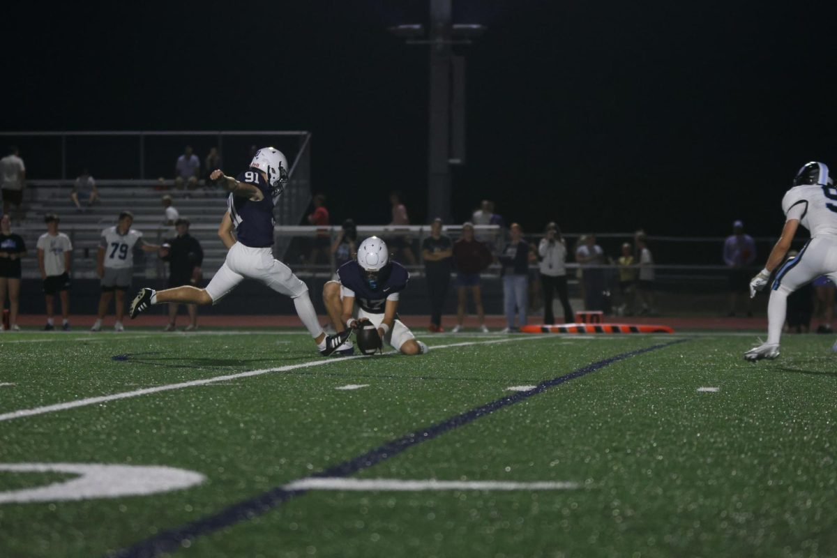 Junior Mason Gellender kicks an extra point to solidify the Jaguars lead 