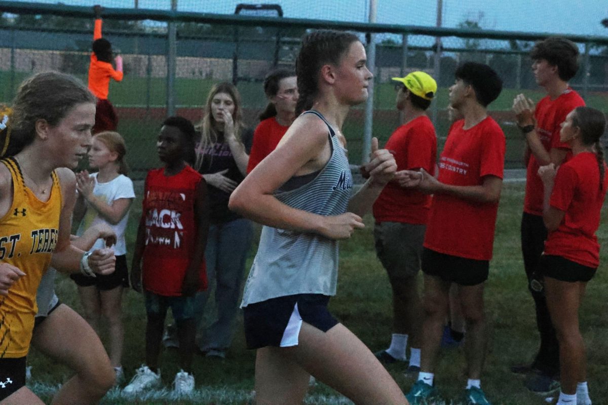 Sophomore Lindsey Maxwell runs hard to stay ahead of her competitor. 