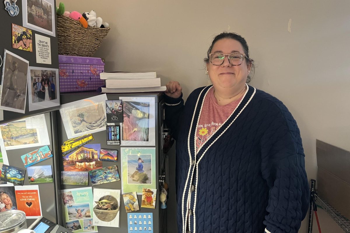 Special Education teacher Lisa Rockhold smiles next to her file cabinet, she enjoys decorating this cabinet with her favorite magnets. 