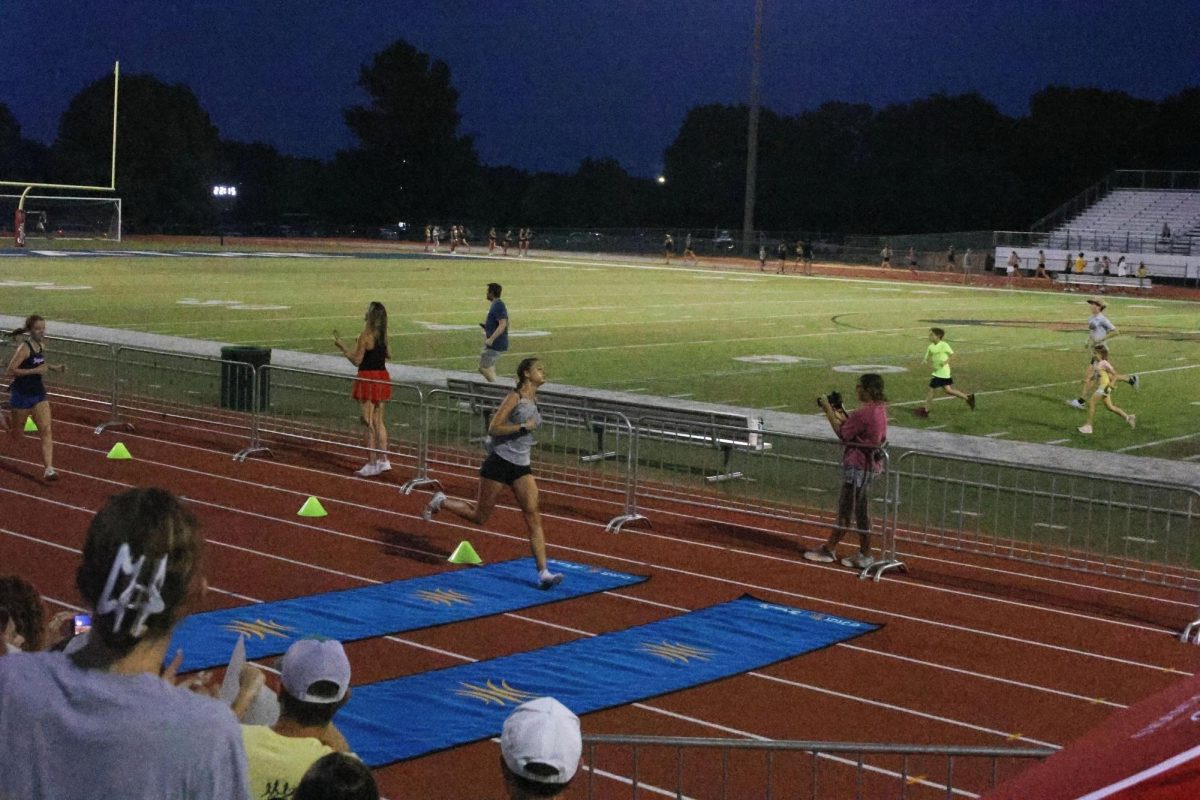 Senior Mae Reynolds sprints through the finish line. 