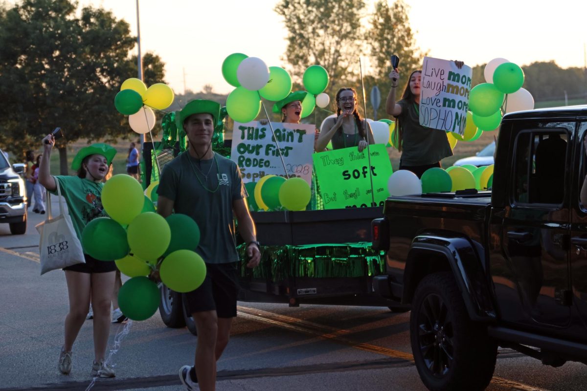 Representing Student Council, sophomores Ava Munsey, Cooper Fanshier, Isabel Mohr, Leah Tucker and Elynne Strack hold up their posters and proudly cheer to the crowd.