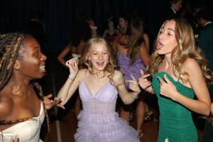 Singing together, sophomore Brynnan King, sophomore Isabella Herman and freshman Loryl Chiles jump to the beat of the music. 