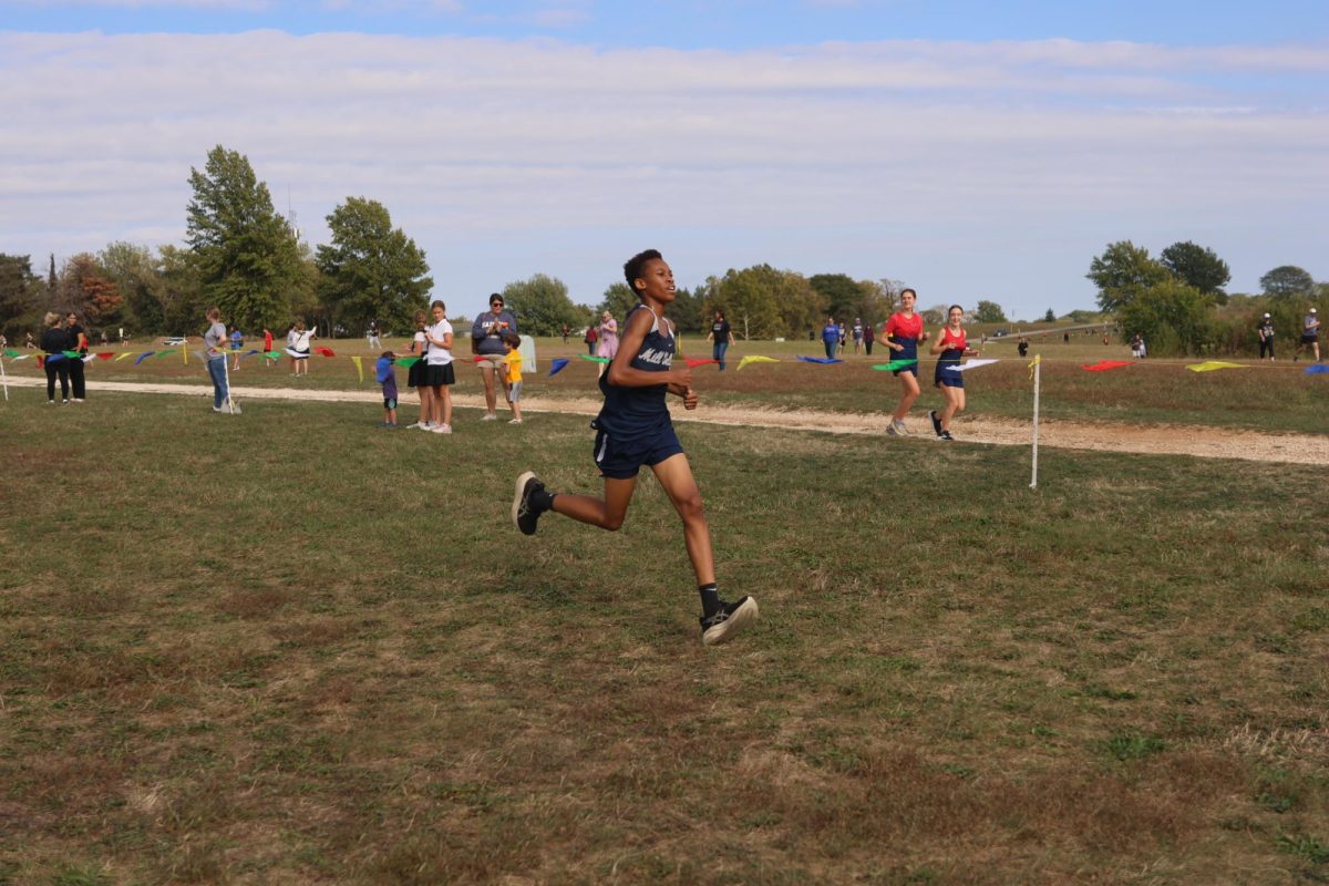 Freshman Jordan Shaw sprints hard to end the race.