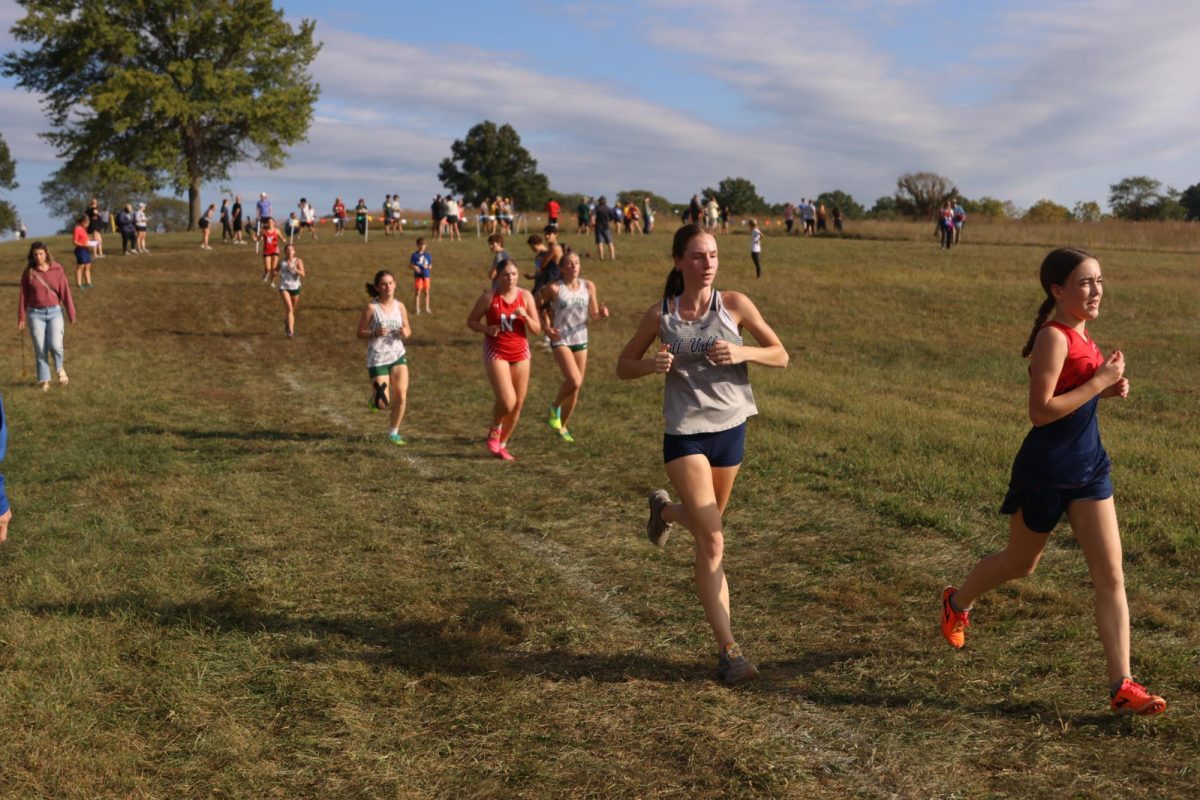 Junior Adelyn Randall quickens her speed to pass her opponent.