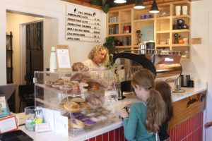 During the lunch rush hour, Betsey Merckens works behind the counter on drinks to serve to her customers, Monday Oct. 21.
