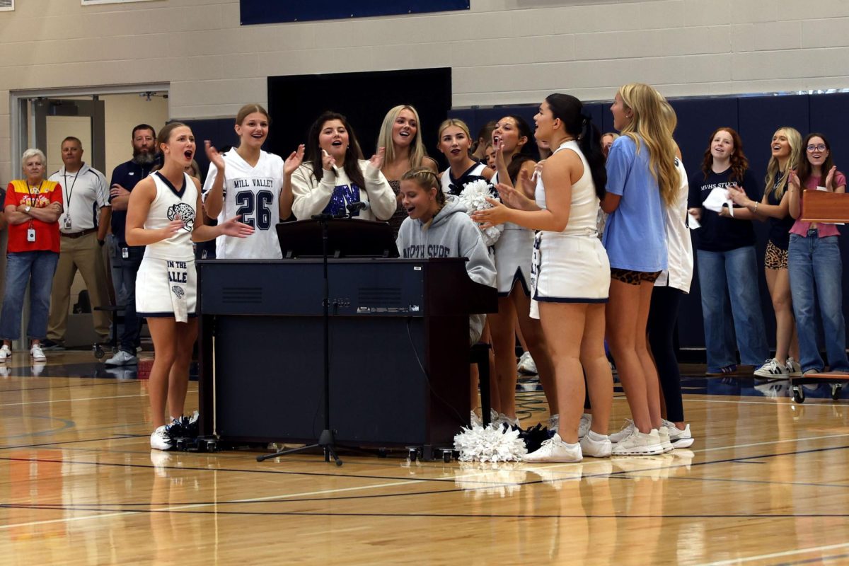 Accompanied by her friends, senior Sienna Suderman performs “Take Me Home, Country Roads” by John Denver on piano to kick off the homecoming pep assembly, Friday, Oct 3rd.
