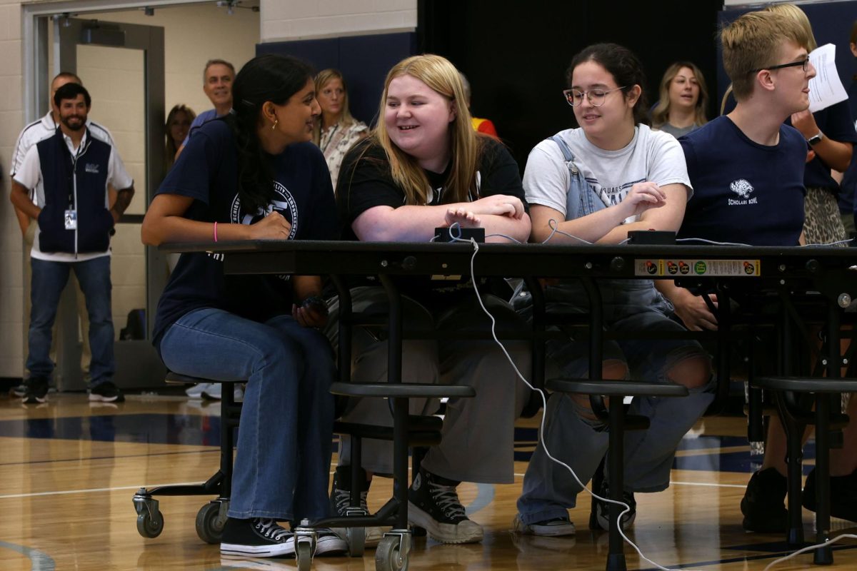 Students on the Scholars Bowl team laugh together while competing against teachers to see who's smarter.