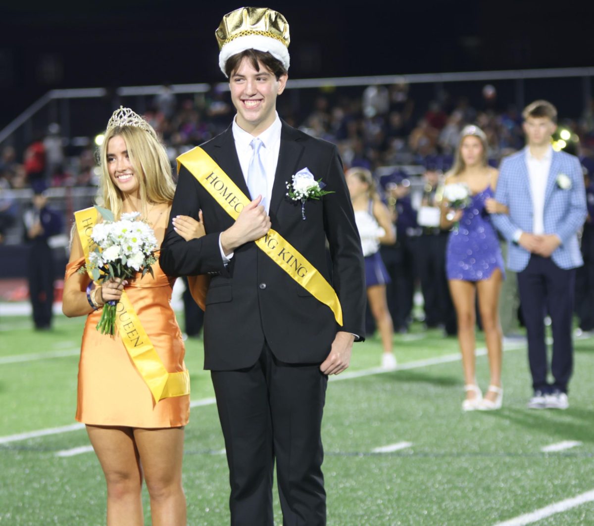 At halftime both Claire Cooper and Barron Fox smile together as they are announced as Homecoming Queen and King
